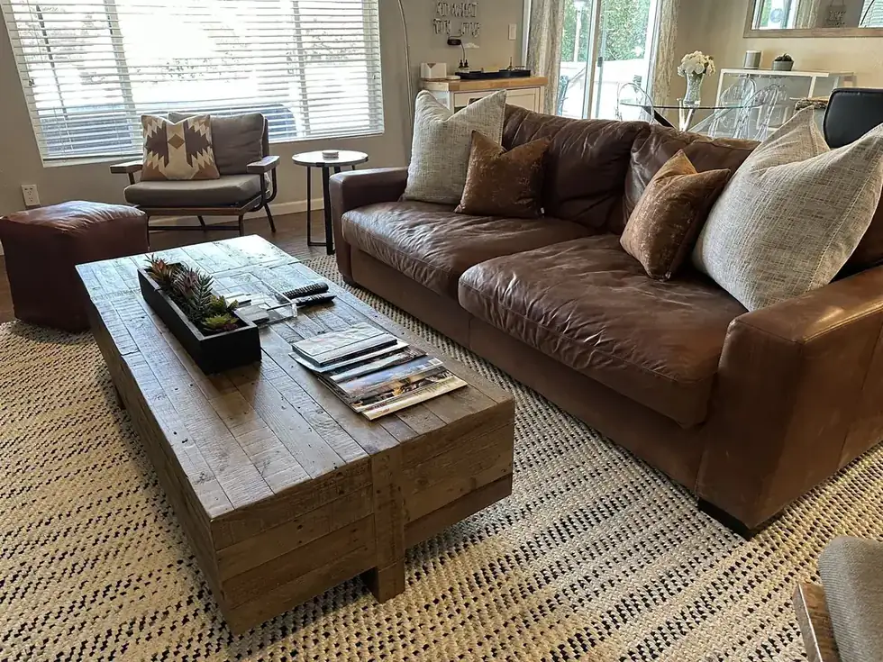 The living room of a Scottsdale rental with a leather
sofa and styled coffee table